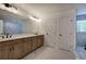 Bright bathroom featuring a double vanity with modern fixtures, a large mirror, and sleek marble floors at 3880 Northpoint Dr, Marietta, GA 30062