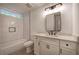 A modern bathroom features a white vanity, a tub, and a subway-tiled shower at 3880 Northpoint Dr, Marietta, GA 30062
