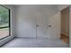 Carpeted bedroom with large window and door at 3880 Northpoint Dr, Marietta, GA 30062