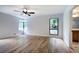 Bright bedroom with hardwood floors, ceiling fan, and large windows offering an abundance of natural light at 3880 Northpoint Dr, Marietta, GA 30062