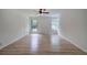 Bright bedroom with hardwood floors, ceiling fan, and large windows offering an abundance of natural light at 3880 Northpoint Dr, Marietta, GA 30062