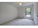 Carpeted bedroom with black trimmed window and ceiling fan at 3880 Northpoint Dr, Marietta, GA 30062
