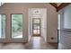 Bright foyer featuring wood floors, a modern glass front door, and large windows offering scenic outdoor views at 3880 Northpoint Dr, Marietta, GA 30062