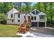 Modern white home featuring a unique architectural design, set against a backdrop of dense, mature trees at 3880 Northpoint Dr, Marietta, GA 30062