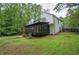 Home's screened in back porch overlooks a lush backyard with a view of trees at 3880 Northpoint Dr, Marietta, GA 30062