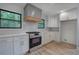 Bright and modern kitchen with white cabinets, stainless steel oven and herringbone backsplash at 3880 Northpoint Dr, Marietta, GA 30062