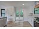 Bright kitchen features stainless steel appliances, white cabinets, hardwood floors and deck access at 3880 Northpoint Dr, Marietta, GA 30062
