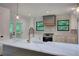 Bright kitchen with a large island, modern appliances, and a view of the backyard at 3880 Northpoint Dr, Marietta, GA 30062