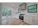 Renovated kitchen boasts stainless steel appliances, white cabinets, and a view to the deck at 3880 Northpoint Dr, Marietta, GA 30062