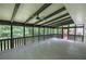 Large screened-in porch featuring beams, ceiling fans, and backyard view at 3880 Northpoint Dr, Marietta, GA 30062