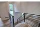 Staircase with a modern metal railing and views to the lower level at 3880 Northpoint Dr, Marietta, GA 30062