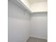 A walk-in closet features a single shelf and minimal carpet at 3880 Northpoint Dr, Marietta, GA 30062