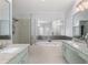 Bathroom featuring separate vanities, a soaking tub, and a glass-enclosed shower at 4656 Ivygate Se Cir, Atlanta, GA 30339
