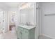 Well-lit bathroom featuring a granite countertop and updated vanity with neutral colored tile flooring at 4656 Ivygate Se Cir, Atlanta, GA 30339
