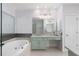 Bright bathroom featuring a luxurious soaking tub and a double vanity with granite countertops at 4656 Ivygate Se Cir, Atlanta, GA 30339