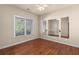 Empty room boasting hardwood floors, natural light from the window and a wall-length mirror at 4656 Ivygate Se Cir, Atlanta, GA 30339