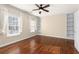 Bedroom features hardwood floors, ceiling fan, built-in bookshelves, and natural light at 4656 Ivygate Se Cir, Atlanta, GA 30339