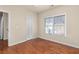 Bedroom offers hardwood floors, a large window, and neutral wall colors at 4656 Ivygate Se Cir, Atlanta, GA 30339