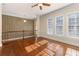 Spacious, bright hallway with wood floors, large windows, decorative wall trim and ceiling fan at 4656 Ivygate Se Cir, Atlanta, GA 30339