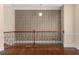 Open hallway features iron railing, decorative wall trim, hanging light fixture and shining wood floors at 4656 Ivygate Se Cir, Atlanta, GA 30339
