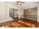 Sunlit hallway features decorative wall trim, wood floors, crown molding, and iron railing leading to a staircase at 4656 Ivygate Se Cir, Atlanta, GA 30339