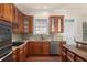 Modern kitchen with wood cabinets, granite countertops, stainless steel appliances, and tile backsplash at 4656 Ivygate Se Cir, Atlanta, GA 30339