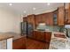 Modern kitchen with stainless steel appliances, custom wood cabinetry, granite countertops, and a tile backsplash at 4656 Ivygate Se Cir, Atlanta, GA 30339