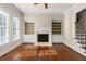 Cozy living room features fireplace, built-in shelving, and wood floors, with staircase access at 4656 Ivygate Se Cir, Atlanta, GA 30339