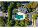 Overhead view of a community pool with lounge area surrounded by mature trees and landscaping at 4656 Ivygate Se Cir, Atlanta, GA 30339