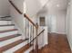 Staircase with dark wood treads and white risers leading to an upper level with neutral decor at 4656 Ivygate Se Cir, Atlanta, GA 30339