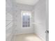 This walk-in closet has built-in shelving and a frosted glass window for privacy at 4656 Ivygate Se Cir, Atlanta, GA 30339
