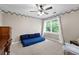 Bedroom featuring blue cushions, neutral paint, white window and a ceiling fan at 5531 Hurstcliffe Nw Dr, Kennesaw, GA 30152