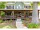 Inviting front porch with stone accents and a cozy swing at 5531 Hurstcliffe Nw Dr, Kennesaw, GA 30152