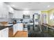 Bright kitchen with white cabinets, granite counters, island seating, stainless appliances at 5531 Hurstcliffe Nw Dr, Kennesaw, GA 30152