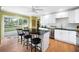 Bright kitchen with white cabinets, granite counters, island seating, stainless appliances, and backyard view at 5531 Hurstcliffe Nw Dr, Kennesaw, GA 30152