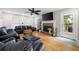 Comfortable living room with a fireplace, hardwood floors, and abundant seating at 5531 Hurstcliffe Nw Dr, Kennesaw, GA 30152