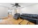 Inviting living room boasts hardwood floors, ceiling fan, and comfortable leather furniture, perfect for relaxation at 5531 Hurstcliffe Nw Dr, Kennesaw, GA 30152