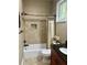 This bathroom features a tub, shower, toilet, and granite countertop sink at 3397 Holly Glen Dr, Dacula, GA 30019