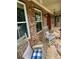 Relaxing front porch featuring rocking chairs on a stone floor, creating a welcoming outdoor space at 3397 Holly Glen Dr, Dacula, GA 30019
