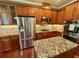 Kitchen with stainless appliances, granite counters, and wood cabinets at 3397 Holly Glen Dr, Dacula, GA 30019