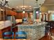 Open kitchen features stainless appliances, granite counters, and stone accents at 3397 Holly Glen Dr, Dacula, GA 30019