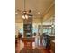 Open living room features a stone fireplace, ceiling fan, and hardwood floors at 3397 Holly Glen Dr, Dacula, GA 30019