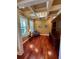 Stylish home office featuring hardwood floors, coffered ceiling, large windows, and built-in shelving at 3397 Holly Glen Dr, Dacula, GA 30019