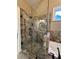 Close up of the shower featuring glass enclosure, shower head, and bench at 3397 Holly Glen Dr, Dacula, GA 30019