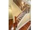 Elegant staircase with dark wood handrail and black iron spindles at 3397 Holly Glen Dr, Dacula, GA 30019