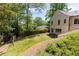 Landscaped backyard with green lawn, trees, and shrubbery providing shade and privacy to the property at 4785 Brinkley Ln, Atlanta, GA 30342