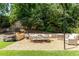 Backyard seating area with dining table and lounge chairs amidst lush greenery at 4785 Brinkley Ln, Atlanta, GA 30342