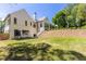 Expansive backyard view of the home's exterior, showcasing a well-maintained lawn and charming architectural details at 4785 Brinkley Ln, Atlanta, GA 30342