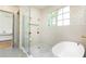 Bright bathroom featuring a modern soaking tub, glass shower, and sleek white tile at 4785 Brinkley Ln, Atlanta, GA 30342