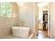 A luxurious soaking tub adjacent to the walk-in closet in this sleek Primary bath at 4785 Brinkley Ln, Atlanta, GA 30342